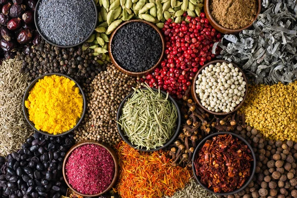 Spices and herbs background. Different seasonings are scattered in color.