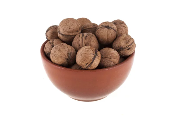 Walnuts in a brown bowl, isolated on white background — Stock Photo, Image