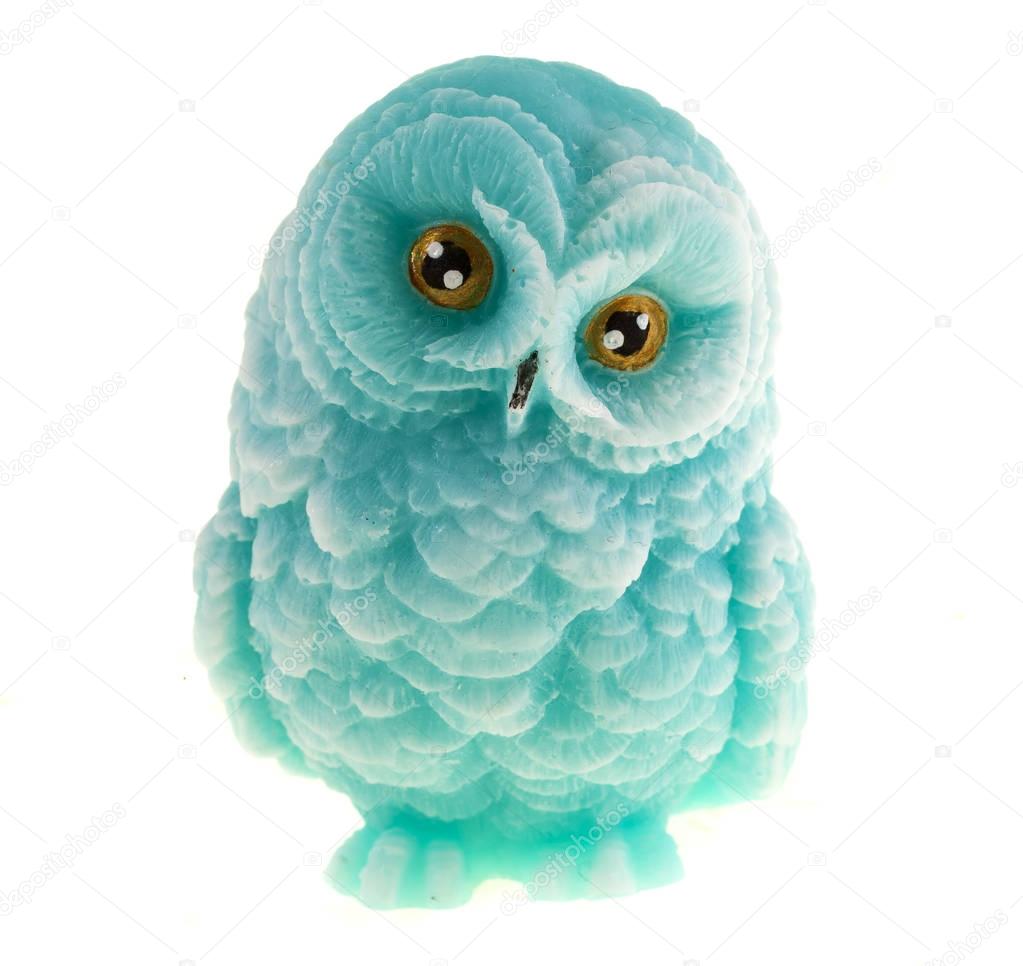 Handmade soap in the shape of an owl on a white background