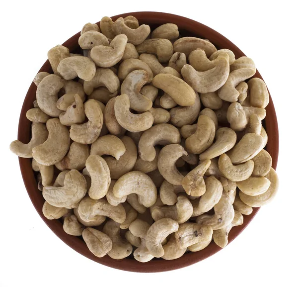 Cashew nuts in a brown bowl, isolated on a white background — Stock Photo, Image