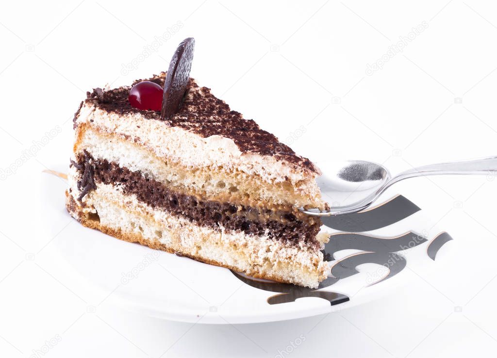 Slice of cake on a plate, isolated on a white background