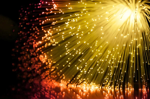 Many Illuminated Golden Fiber Optic Light Strands Cascading Reflecting ...