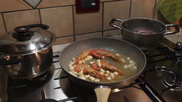 Mettre le persil à la main sur une casserole où les crevettes sont cuites — Video