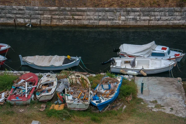 New boats moored next to destroyed old boats