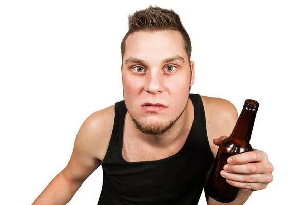 Young guy alcoholic with headache holding bottle of beer isolated on white background — Stock Photo, Image