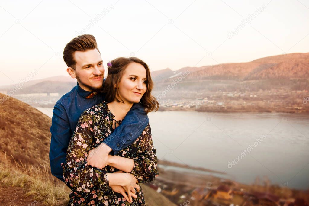 Couple in love happy walks and embrace on the river background