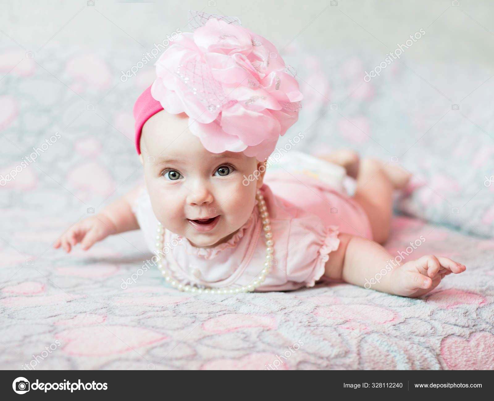 Portgait Of Little Baby Girl In Pink Dress On Light Pink Background