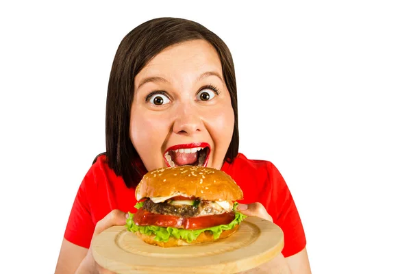 Young fat woman holds hamburger, smiles with opened mouth isolated on white background. — 스톡 사진