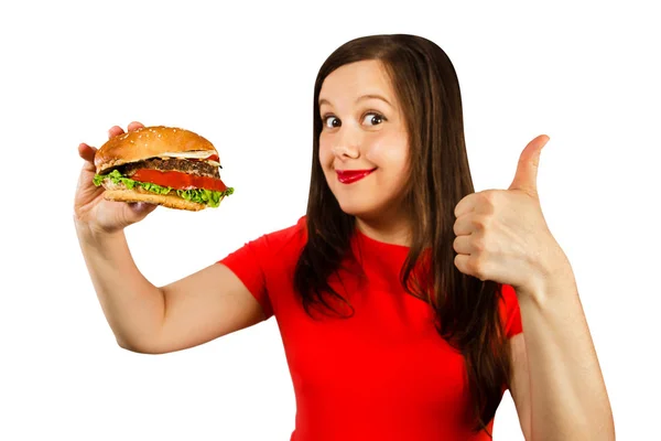 Young fat woman holds hamburger, smiles with opened mouth isolated on white background. — 스톡 사진