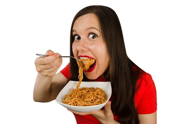 Young girl in a red t shirt eats chinese noodles isolated on a white background. — 스톡 사진