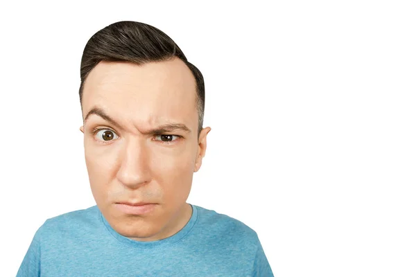 Young gloomy man dressed in a blue t shirt on a isolated white background. — Stock Photo, Image