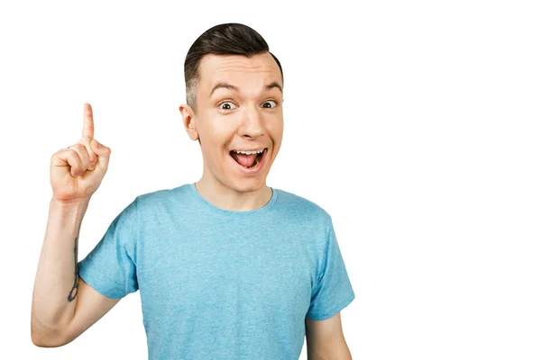 Idea Joven chico sonriente con el dedo en alto, vestido con una camiseta azul sobre un fondo blanco aislado . — Foto de Stock