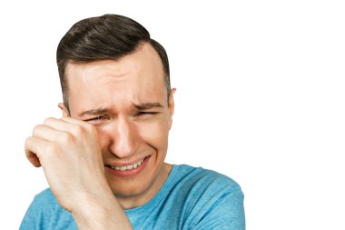 Ağlayan genç adam, elleri açık, ağzı açık, mavi tişörtlü, izole edilmiş beyaz arka planda..