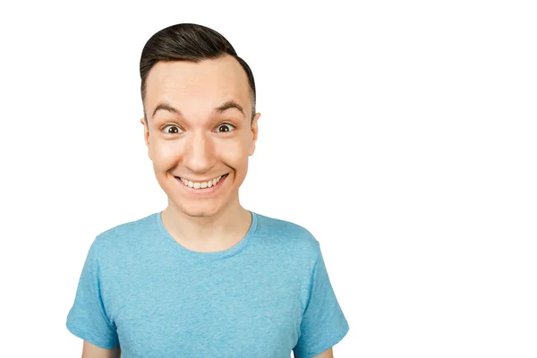 Detailní záběr portrét mladého šťastného usmívajícího se chlapa, oblečený v modré tričko na světlém pozadí. — Stock fotografie
