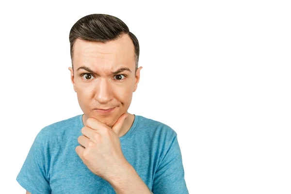 Young thinking man dressed in a blue t-shirt on a isolated white background. — Stock Photo, Image