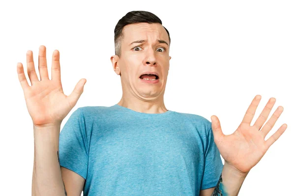 A young guy in a blue T-shirt refuse, show a gesture with his hands and palms on a isolated white background — Stock Photo, Image