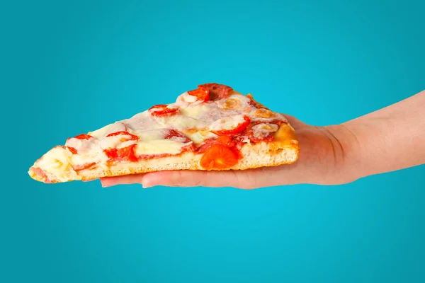 Hand holds piece of pizza isolated on orange background. — 스톡 사진