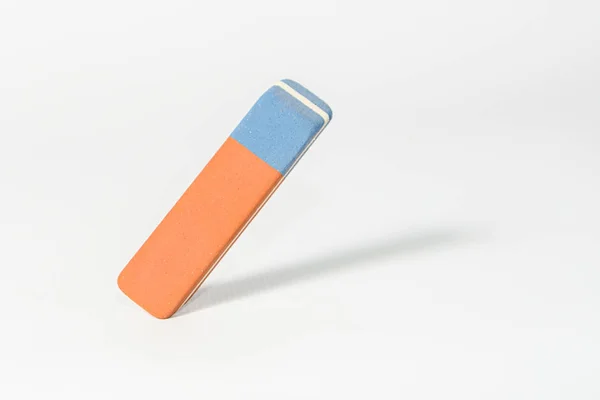 Eraser stands in the air without someone and erases paper light background — Stock Photo, Image