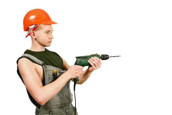 Young working guy in hard hat holds drill isolated on a white background — Stock Photo, Image