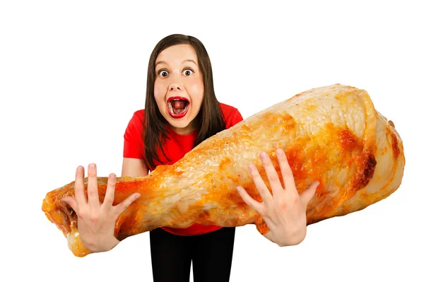 Young cute funny girl holds in front of herself huge chicken leg isolated on a white background — 스톡 사진