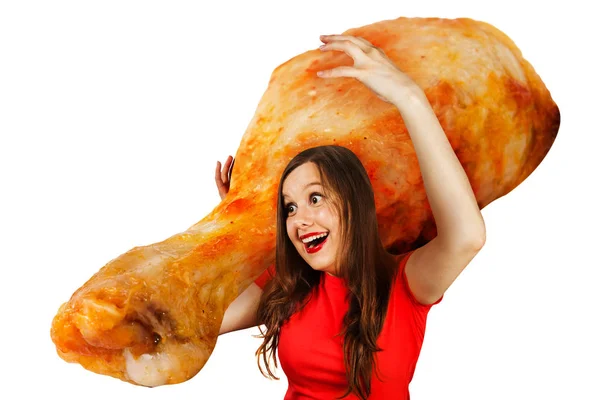 Young cute funny girl holds in front of herself huge chicken leg isolated on a white background — 스톡 사진