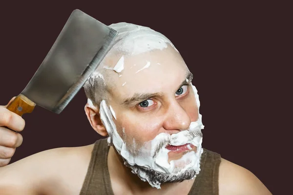 早上，一个留着胡子，手里拿着剃须刀，脸上沾满泡沫和胶水的男人在家里刮胡子. — 图库照片