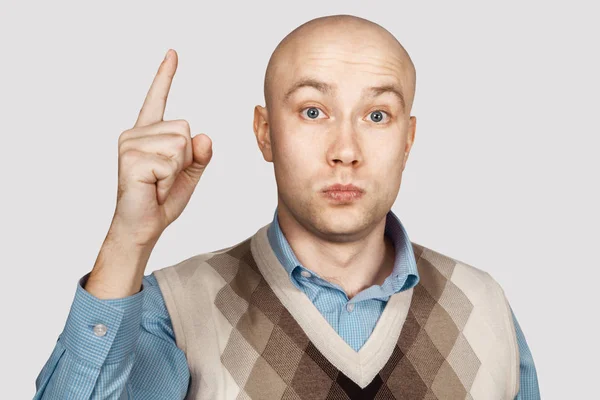 Bald serious man points and threatens with forefinger — Stock Photo, Image