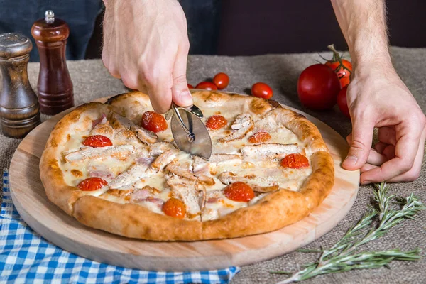 Pizza Cutter Homemade pizza with ham, bacon, Cheese, meat, tomatoes