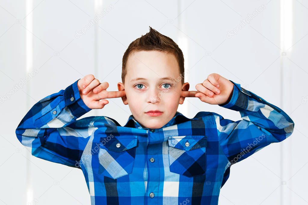 boy cover his ears ignore noise. on white background