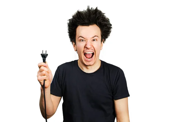 Långt hår kille håller en elektrisk kontakt med en kabel i handen på en vit isolerad bakgrund — Stockfoto