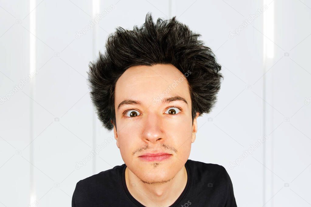 shaggy guy with long hair looks in camera, on isolated background
