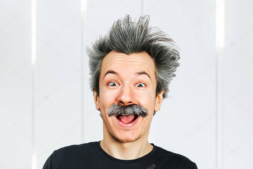 Portrait of jocular aging man with grey long hair smiling with open mouth, in Einstein manner