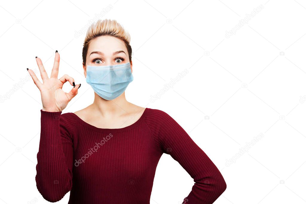 young woman sign ok, wearing protective face mask prevent virus infection, pollution, white isolated background.