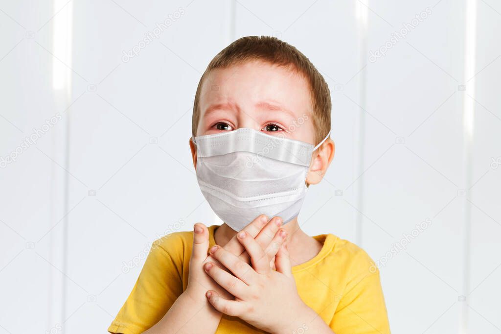 worried child wearing a protective face mask to prevent virus infection or pollution .