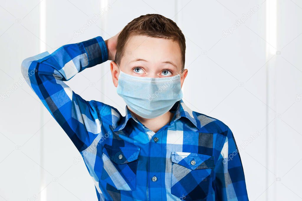 Portrait of thinking boy, wearing a protective face mask prevent virus infection, pollution.