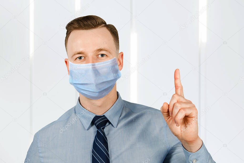 man wearing protective face mask prevent virus infection, pollution with idea pointing finger.