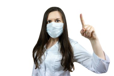 Covid19, koronavirüs, kadın doktor fikri ile parmak işareti, virüsün bulaşmasını önlemek için tıbbi maske takmak, beyaz önlük.