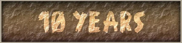 10 YEARS written with paint on rock panel background — Stock Photo, Image