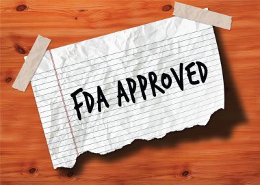 Yırtık defter sayfası buruşuk Kağıt ahşap doku arka plan üzerinde el yazısı FDA onaylı.
