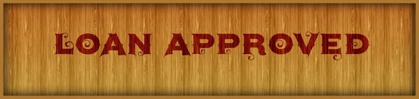 Vintage font text LOAN APPROVED on square wood panel background.