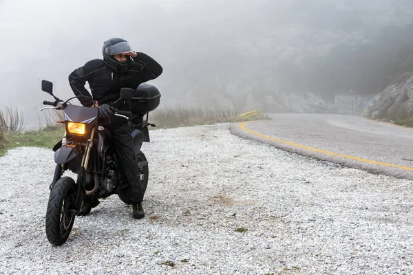 Rider trying to see through the fog on an adventure ride on the Royalty Free Stock Images