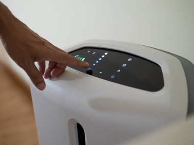 Yatak odasında hava temizleyicisi var. Hava temizleyicisi ince tozu temizliyor.