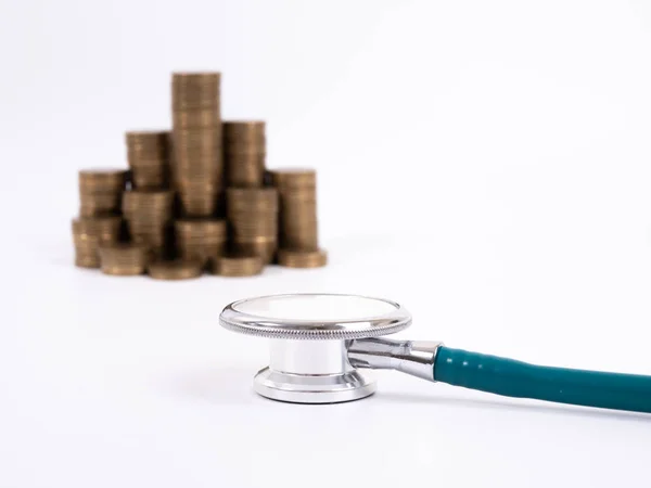 Stethoscope on coin stack, on white background. money for health — 스톡 사진