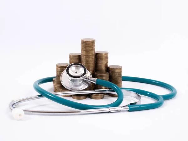 Medical stethoscope and coins stack isolated on white background — Stock Photo, Image