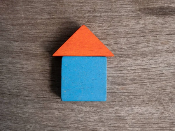 Wooden house toy with wood background