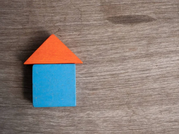 Wooden house toy with wood background