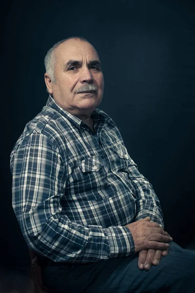 Thoughtful middle aged man in check shirt — Stock Photo, Image