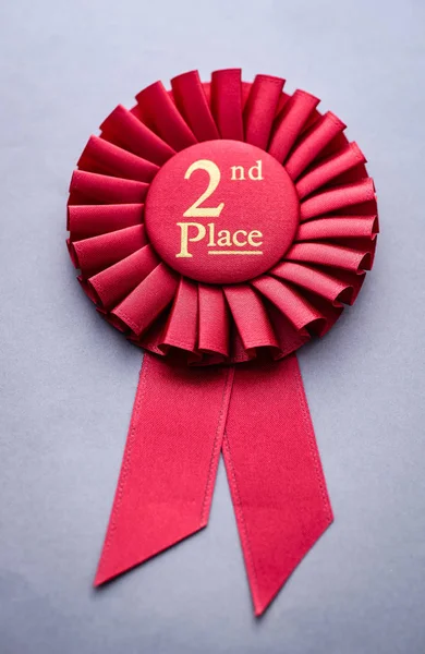 Second place red winners rosette on grey — Stock Photo, Image