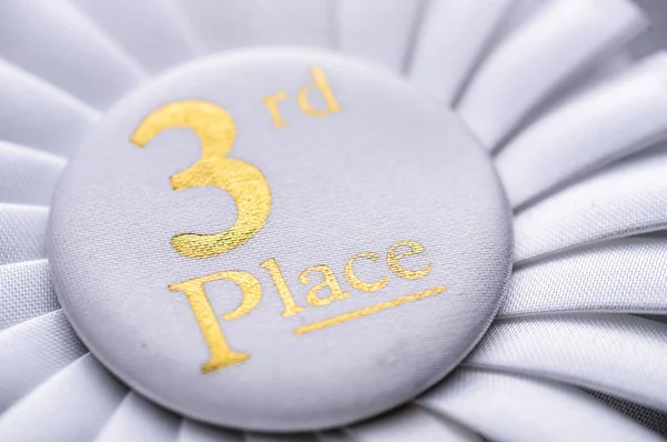 Third place winners white rosette with gold text — Stock Photo, Image