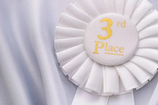 White fabric award ribbon for the 3rd place — Stock Photo, Image